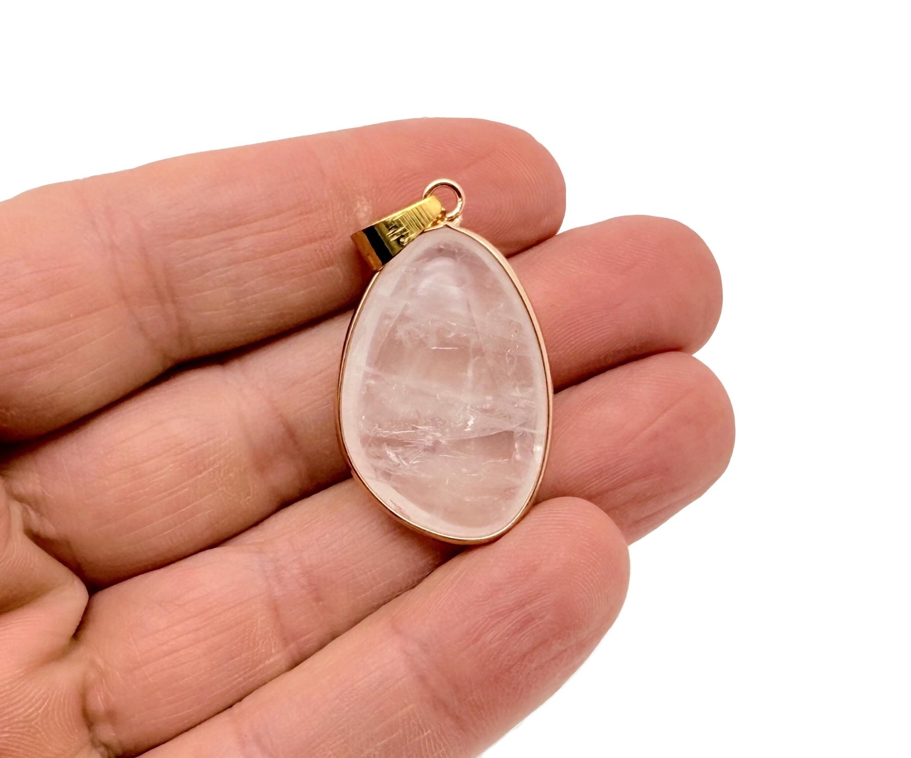 Dainty clear quartz gemstone pendant with gold setting, perfect for DIY jewelry charms, featuring a polished, transparent stone.