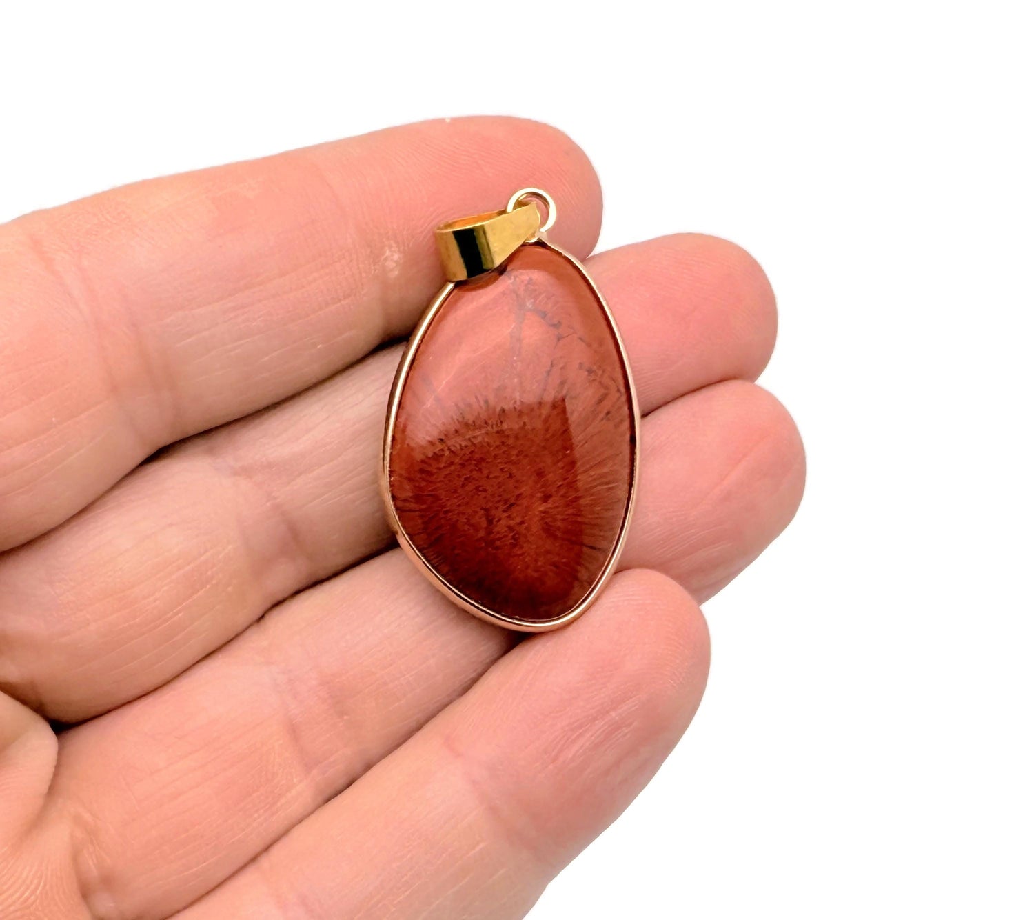 Dainty red jasper gemstone pendant with gold accents, ideal for DIY jewelry charms, showcasing a polished, natural stone design.
