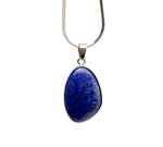 Dainty silver pendant featuring a polished lapis lazuli gemstone for jewelry DIY charms, with intricate silver detailing.