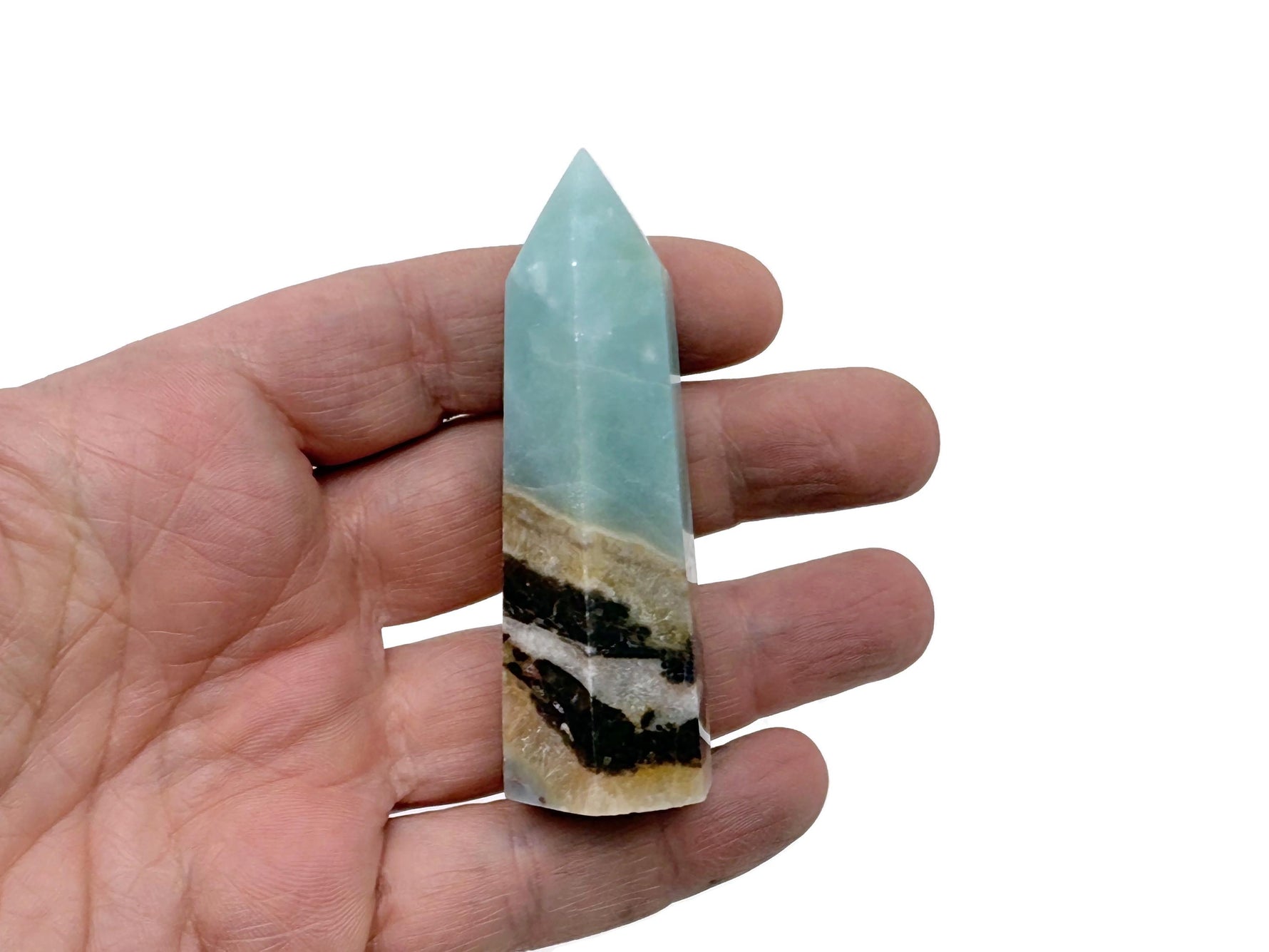Caribbean Calcite obelisk tower crystal from GemstoneGO, showing a polished mineral with natural orange and white hues.