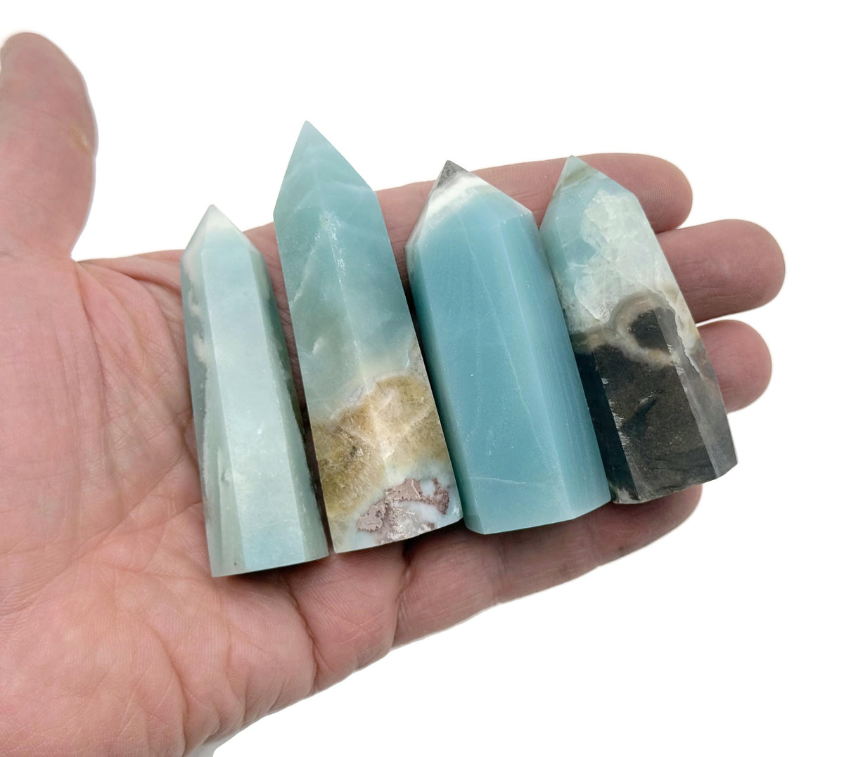 Caribbean calcite obelisk tower crystal from GemstoneGO featuring a tall, polished natural stone with vibrant orange and cream hues