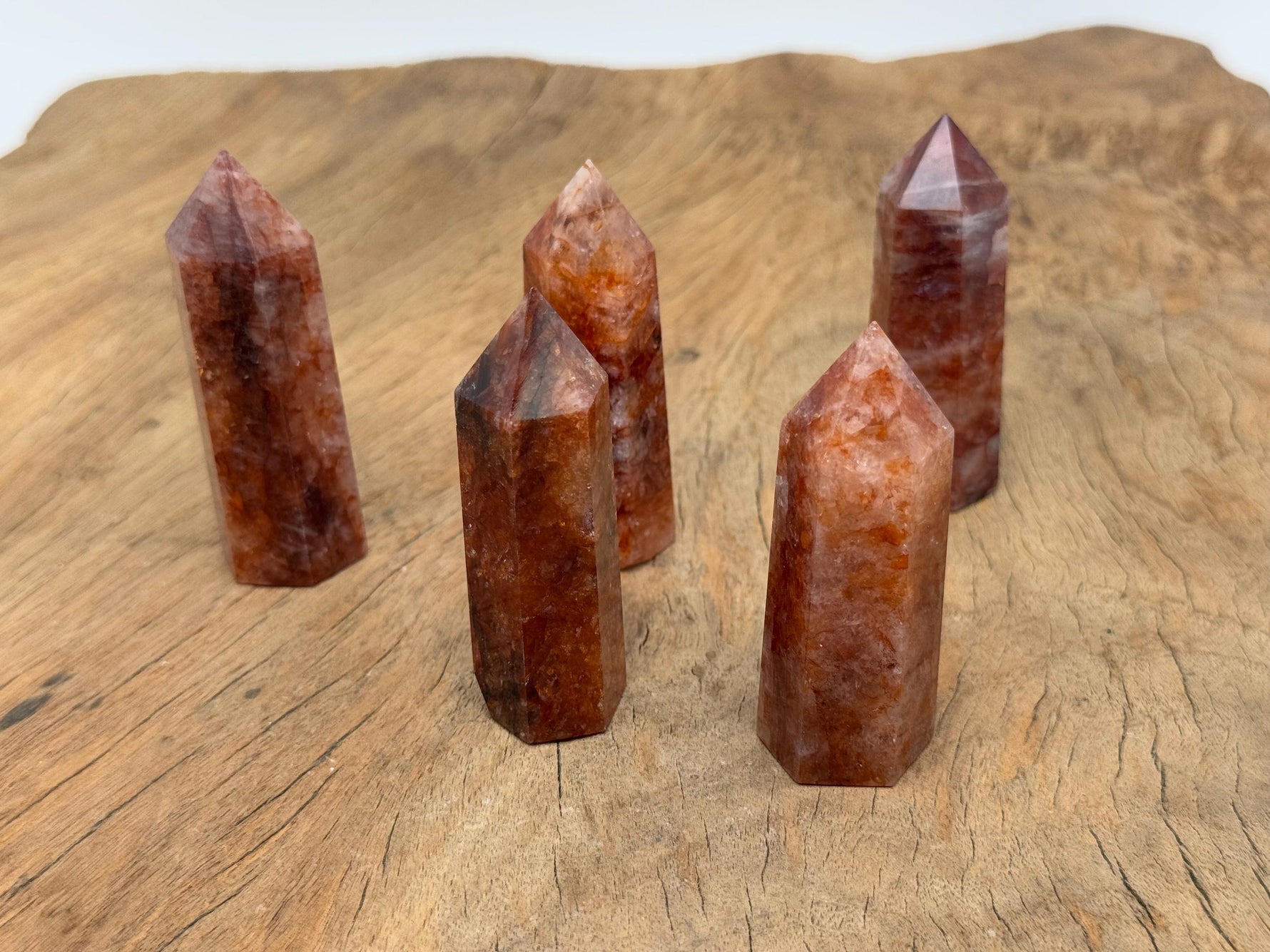 Red Hematoid Quartz fire quartz obelisk tower crystal from GemstoneGO, showcasing a vibrant red and clear gemstone with natural crystal formations.