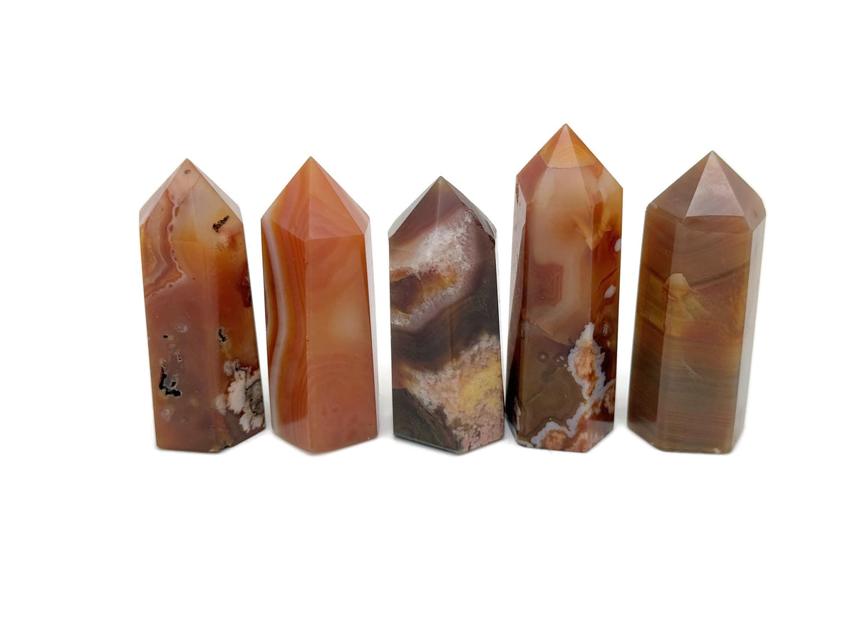 Carnelian obelisk tower crystal from GemstoneGO, showing a vibrant orange gemstone with a pointed top and smooth polished surface.