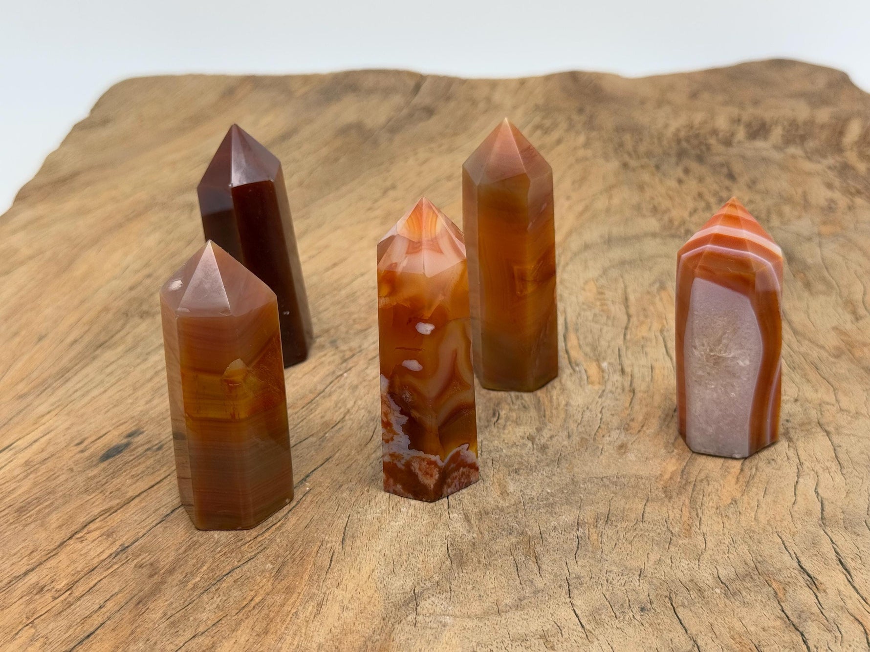 Carnelian obelisk tower crystal from GemstoneGO, showcasing a vibrant orange gemstone with polished, pointed design.