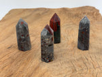 African Bloodstone obelisk tower crystal from GemstoneGO, showcasing a dark green stone with red blood-like mineral veins.