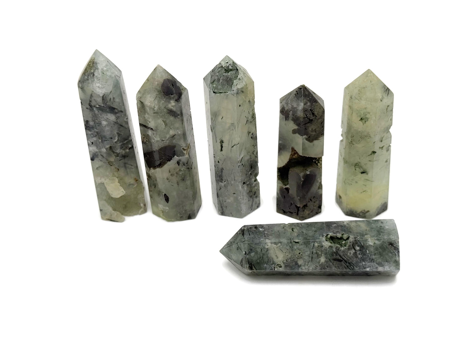 Prehnite obelisk tower crystal from GemstoneGO, showcasing a smooth, green gemstone with natural mineral patterns and a pointed tip.