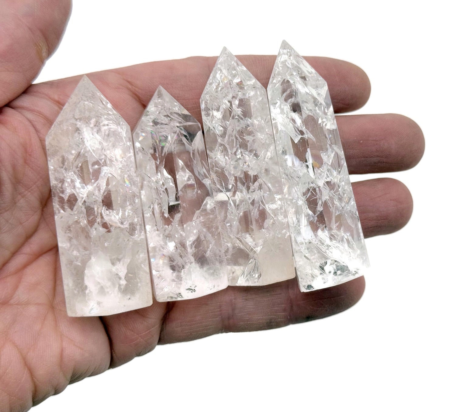 Cracked clear quartz obelisk tower crystal from GemstoneGO, showcasing a tall, pointed stone with natural internal fractures.