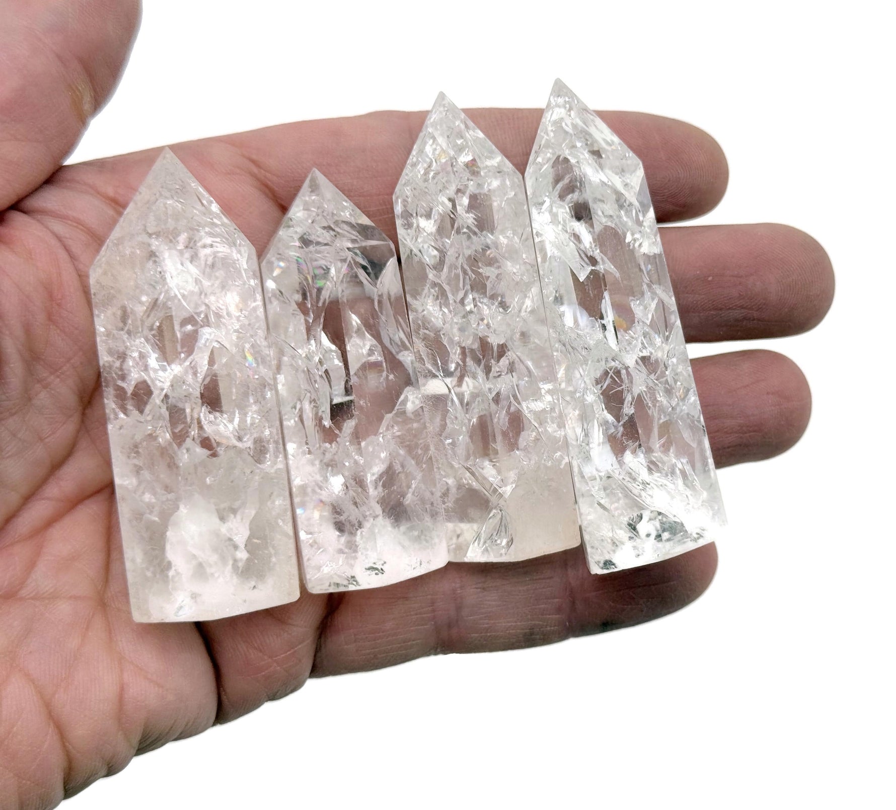 Cracked clear quartz obelisk tower crystal from GemstoneGO, showcasing a tall, pointed stone with natural internal fractures.