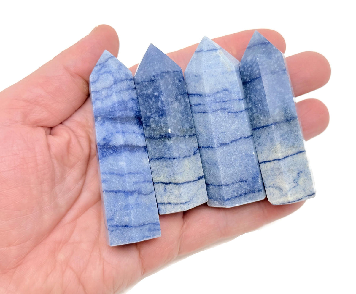 Blue aventurine obelisk tower crystal from GemstoneGO, featuring a polished blue gemstone obelisk with natural veining and smooth surfaces.