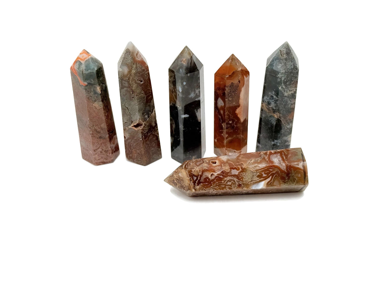 Water Grass Agate obelisk tower crystal from GemstoneGO, showcasing a polished stone with green, tan, and white natural banding.