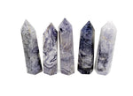 Purple lavender lace agate obelisk tower crystal from GemstoneGO, showcasing a tall, polished purple and blue gemstone with intricate lace pattern.