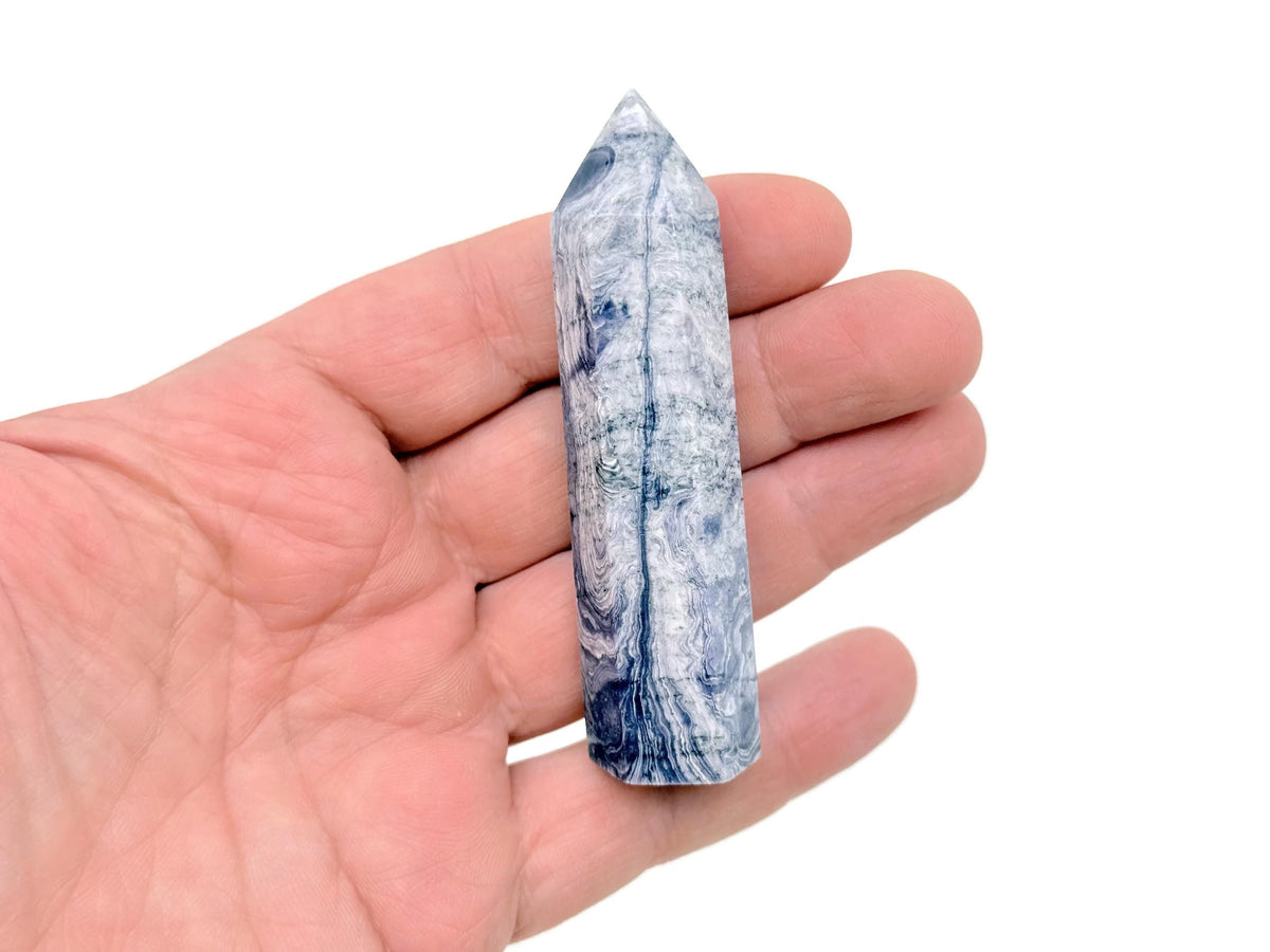 Purple Lavender Lace Agate obelisk tower crystal from GemstoneGO, showcasing a polished, violet and white banded gemstone shape.