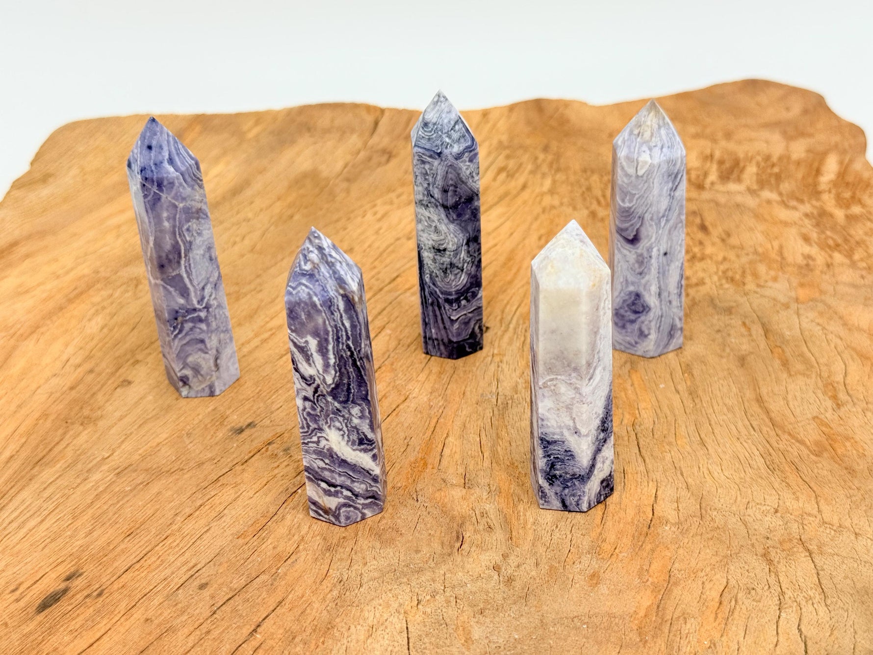 Purple Lavender Lace Agate obelisk tower crystal by GemstoneGO, showcasing a smooth, polished lavender and purple stone with natural patterns.