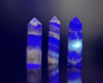 Fluorescent fluorite agate obelisk tower crystal from GemstoneGO, showcasing vibrant colors and natural stone textures.