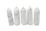 Mexican White Agate obelisk tower crystal from GemstoneGO, showcasing smooth polished white stone with natural banding details.