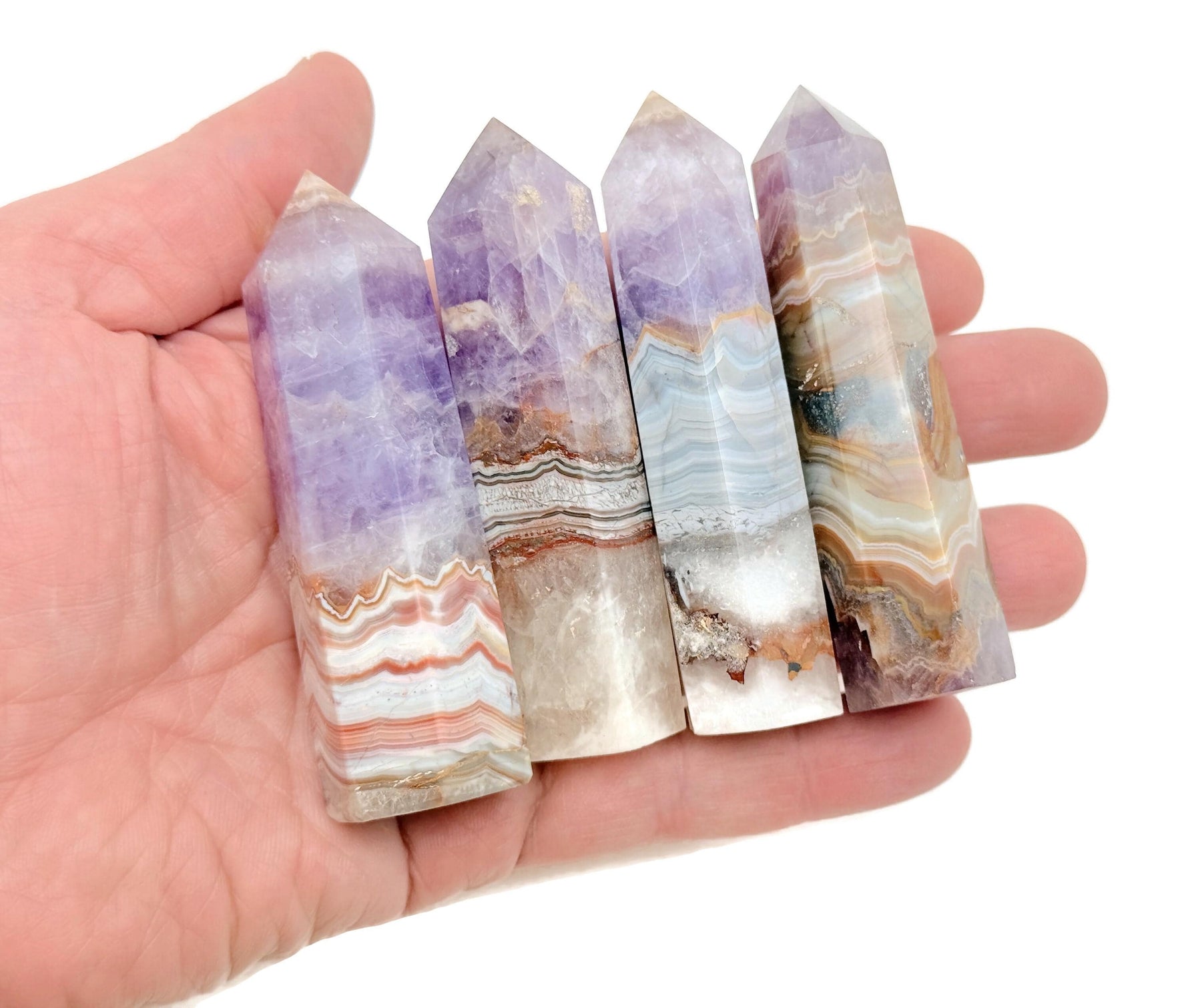 Amethyst Crazy Lace Agate obelisk tower crystal from GemstoneGO, showcasing purple and patterned banding on a polished stone.