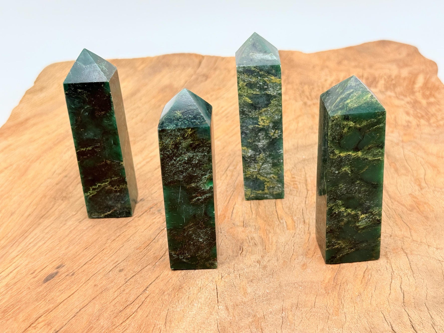 Emerald Quartz obelisk tower crystal from GemstoneGO, featuring a green, polished gemstone obelisk with natural crystal details.