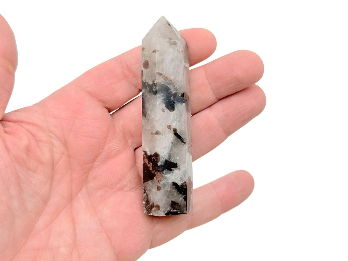 Garnet and black tourmaline obelisk tower crystal from GemstoneGO, showing polished gemstone with pointed top and natural stone textures.