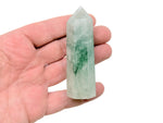 Green rutilated quartz obelisk tower crystal by GemstoneGO, showcasing a polished green quartz crystal with needle-like rutile inclusions.