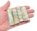 Caribbean Green Calcite obelisk tower crystal from GemstoneGO, showcasing a vibrant green mineral with smooth polished surface.