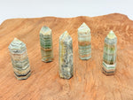 Caribbean Green Calcite obelisk crystal tower from GemstoneGO with smooth, polished surface and vibrant green color.
