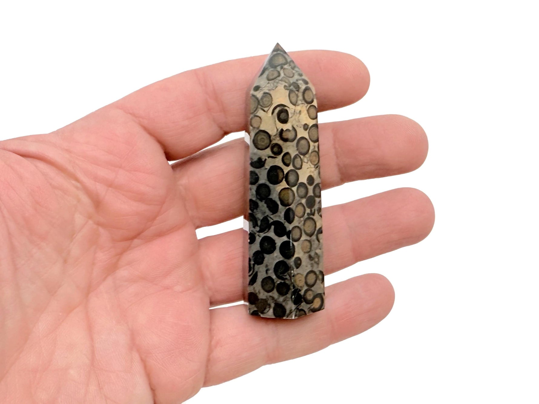 Leopard skin Jasper obelisk tower crystal from GemstoneGO, showcasing a tall, polished stone with distinctive spotted patterns.