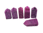 Red corundum obelisk tower crystal from GemstoneGO, showcasing a vibrant, polished gemstone with a pointed obelisk shape.