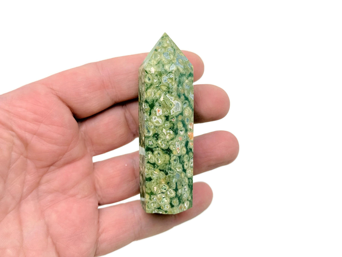 Rhyolite obelisk tower crystal from Rainforest collection by GemstoneGO, featuring a polished, natural stone with a pointed tip.