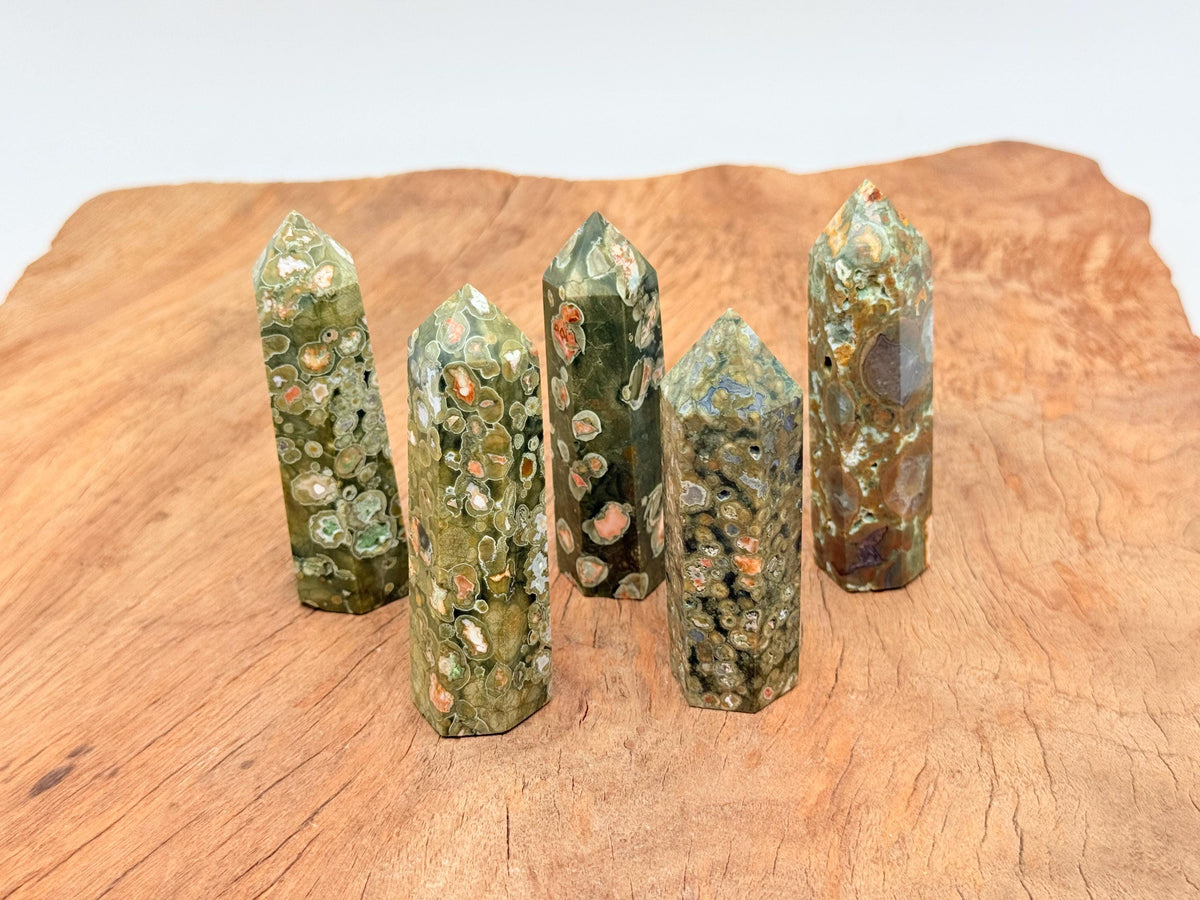Rhyolite obelisk tower crystal from GemstoneGO featuring vibrant rainforest colors and polished surface.