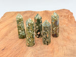 Rhyolite obelisk tower crystal from GemstoneGO featuring vibrant rainforest colors and polished surface.