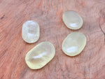 Citrine palm gemstone spa stone by GemstoneGO, smooth yellow citrine crystal used for relaxation and massage therapy.