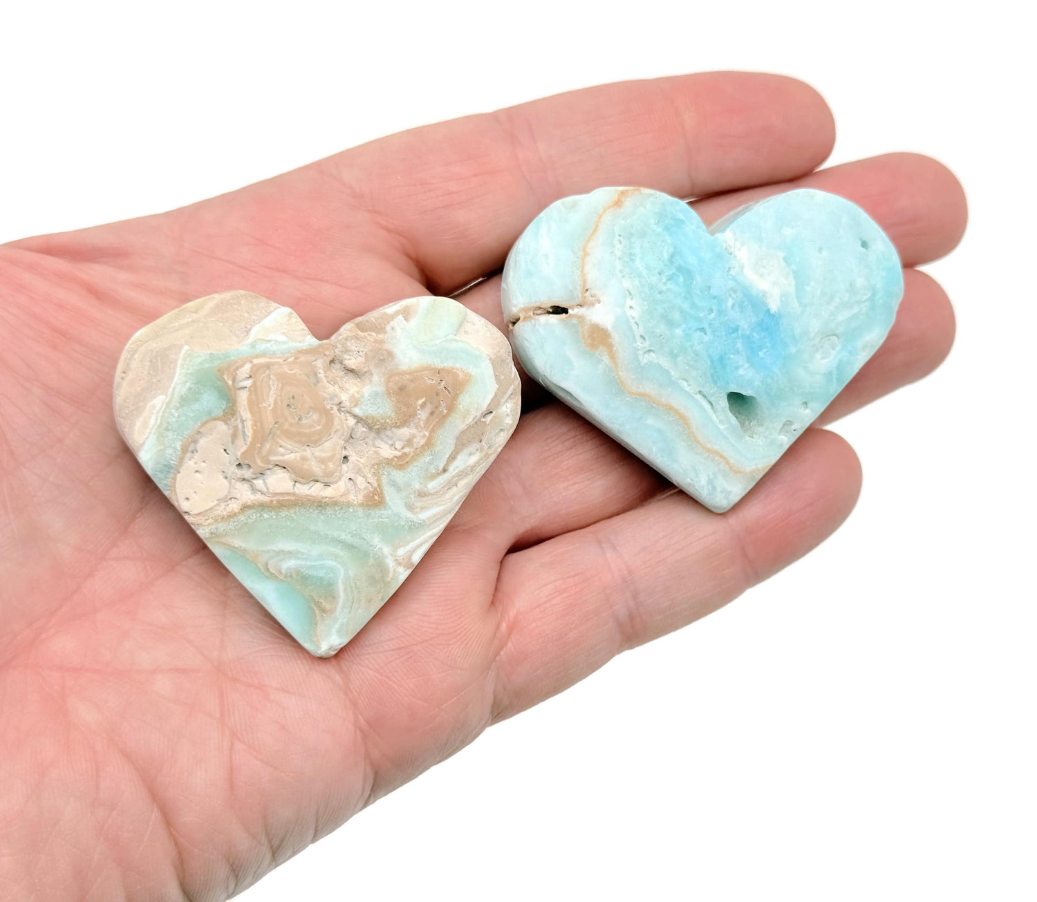 Caribbean Calcite Heart gemstone from GemstoneGO, polished pink-orange mineral with a smooth heart shape and vibrant coloration.