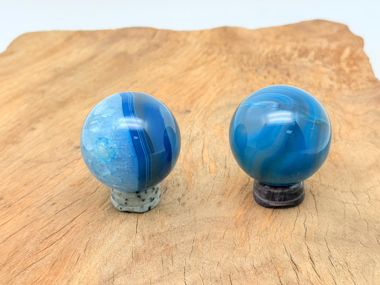 Blue agate gemstone sphere, crystal ball, 50-60mm, polished stone with vibrant blue and white banding, classic decorative mineral.