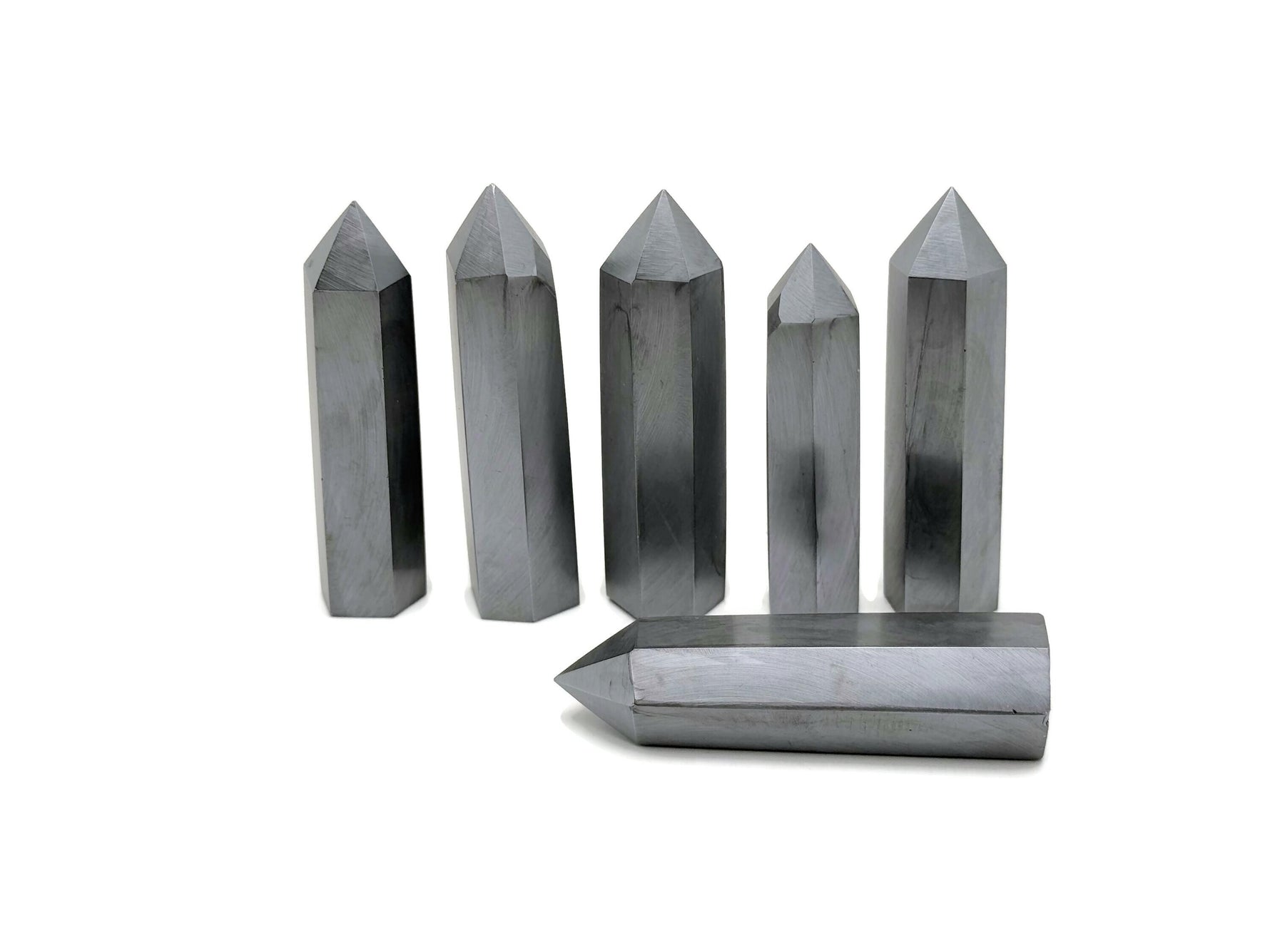 Terahertz Obelisk Tower Crystal by GemstoneGO, showcasing a sleek, polished gemstone obelisk with natural crystal patterns and a pointed top.