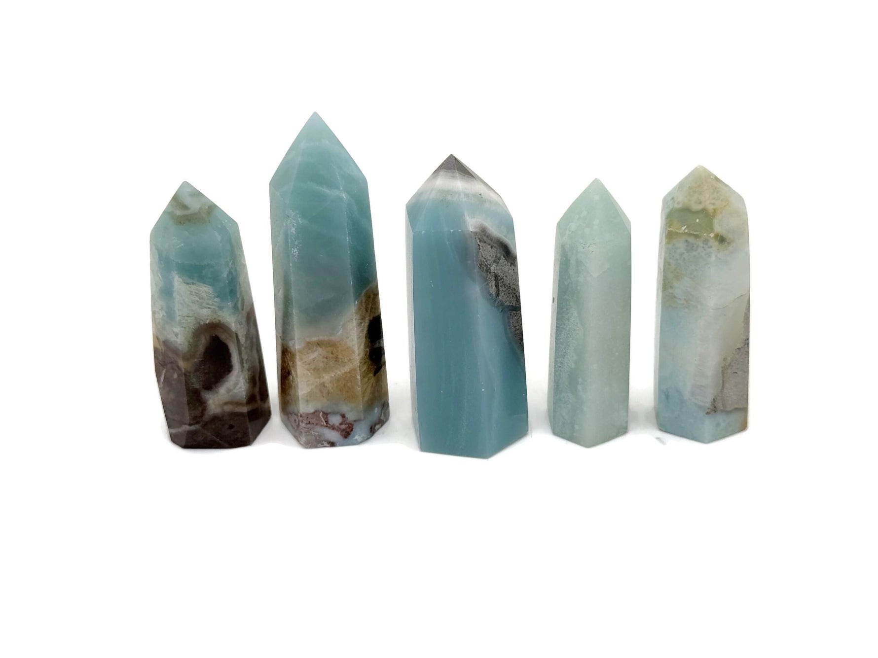 Caribbean calcite obelisk tower crystal from GemstoneGO, featuring a polished, pointed crystal structure in warm orange and yellow hues.
