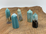 Caribbean Calcite obelisk crystal tower by GemstoneGO, showcasing a natural stone with warm orange and cream tones.