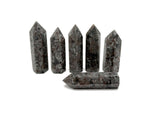 Yooperlite obelisk tower crystal with glowing fluorescent sodalite stone, showcasing vibrant blue and purple hues under UV light.