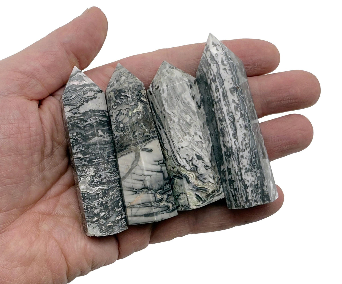 Picasso Jasper obelisk tower crystal from GemstoneGO showing a polished, natural stone with unique blue, brown, and cream patterns.