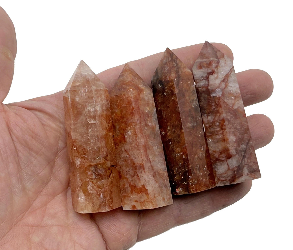 Red Hematoid Quartz Fire Quartz obelisk tower crystal from GemstoneGO, showcasing a striking red and clear gemstone with a pointed tip.