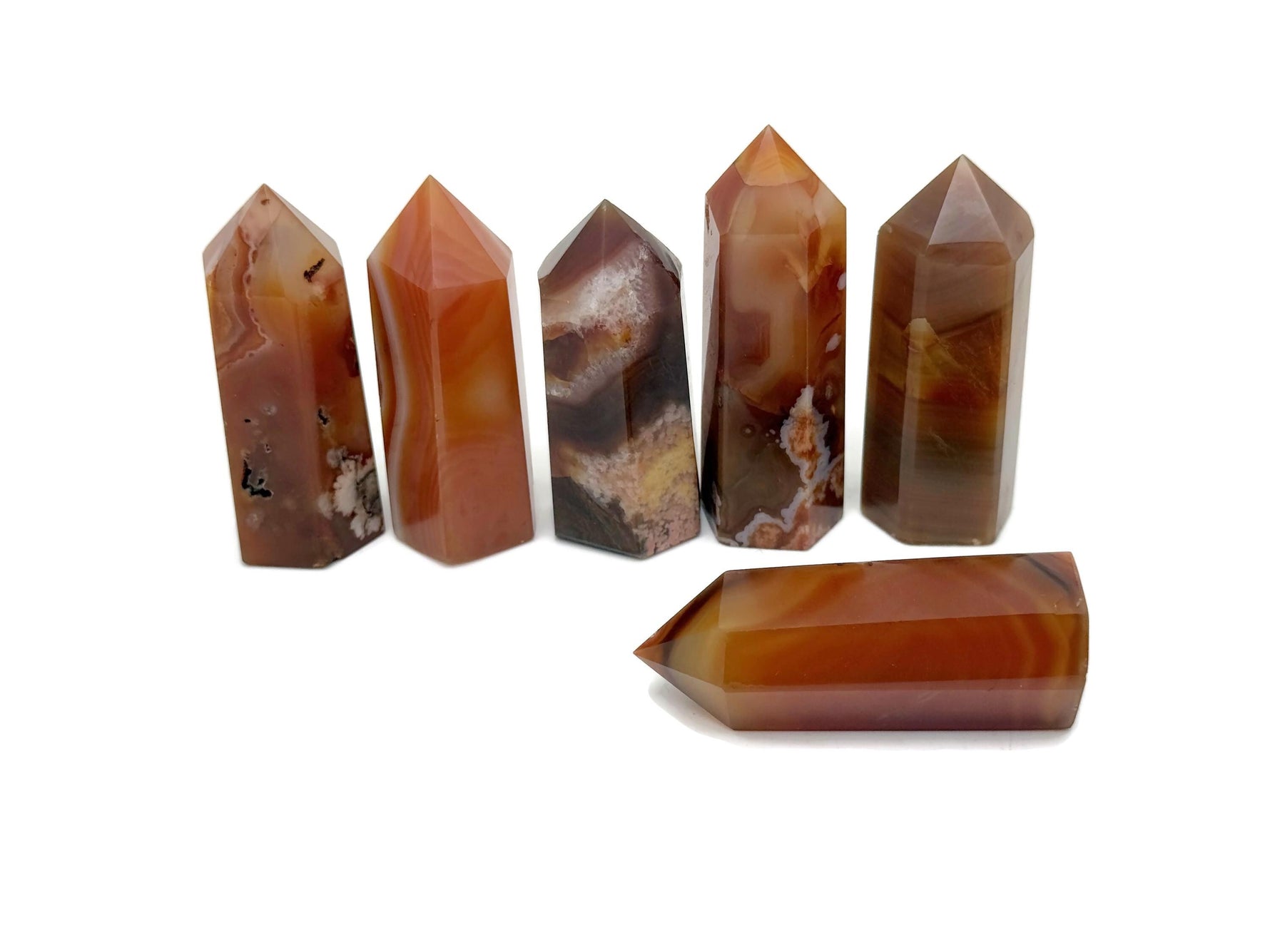 Carnelian obelisk tower crystal from GemstoneGO, showcasing a vibrant orange gemstone with a polished pointed shape.