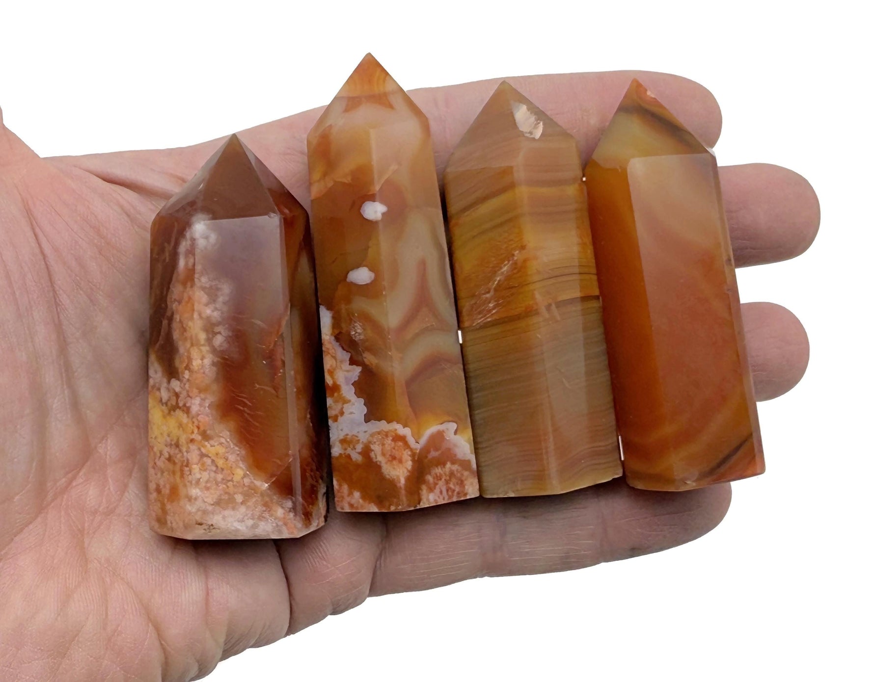 Carnelian obelisk tower crystal from GemstoneGO, showcasing a vibrant orange gemstone with smooth polished surfaces and pointed top.