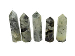 Prehnite obelisk tower crystal from GemstoneGO, showcasing smooth green mineral with natural stone textures and polished surfaces.