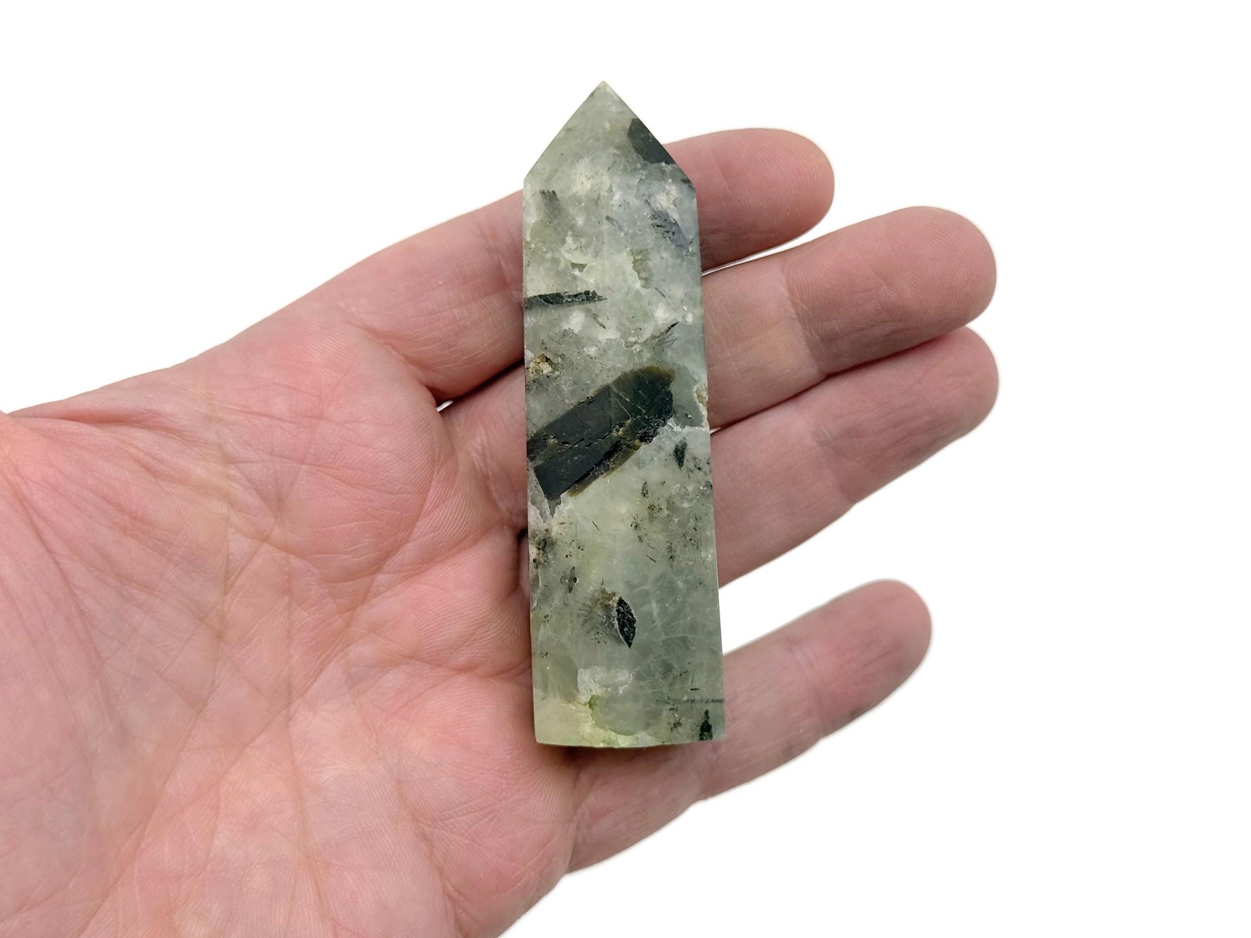 Prehnite obelisk tower crystal from GemstoneGO showcasing a smooth green mineral with natural stone textures and polished surfaces.