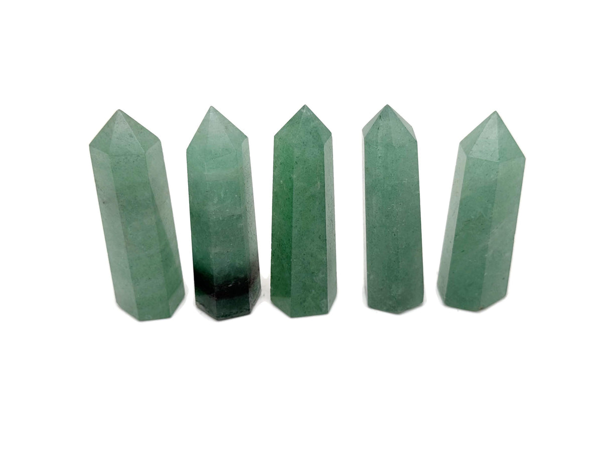 Green strawberry quartz obelisk tower crystal from GemstoneGO, featuring a polished green quartz crystal with natural striations and a pointed top.