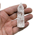 Cracked clear quartz obelisk tower crystal by GemstoneGO, featuring a tall, pointed quartz crystal with natural crack patterns.