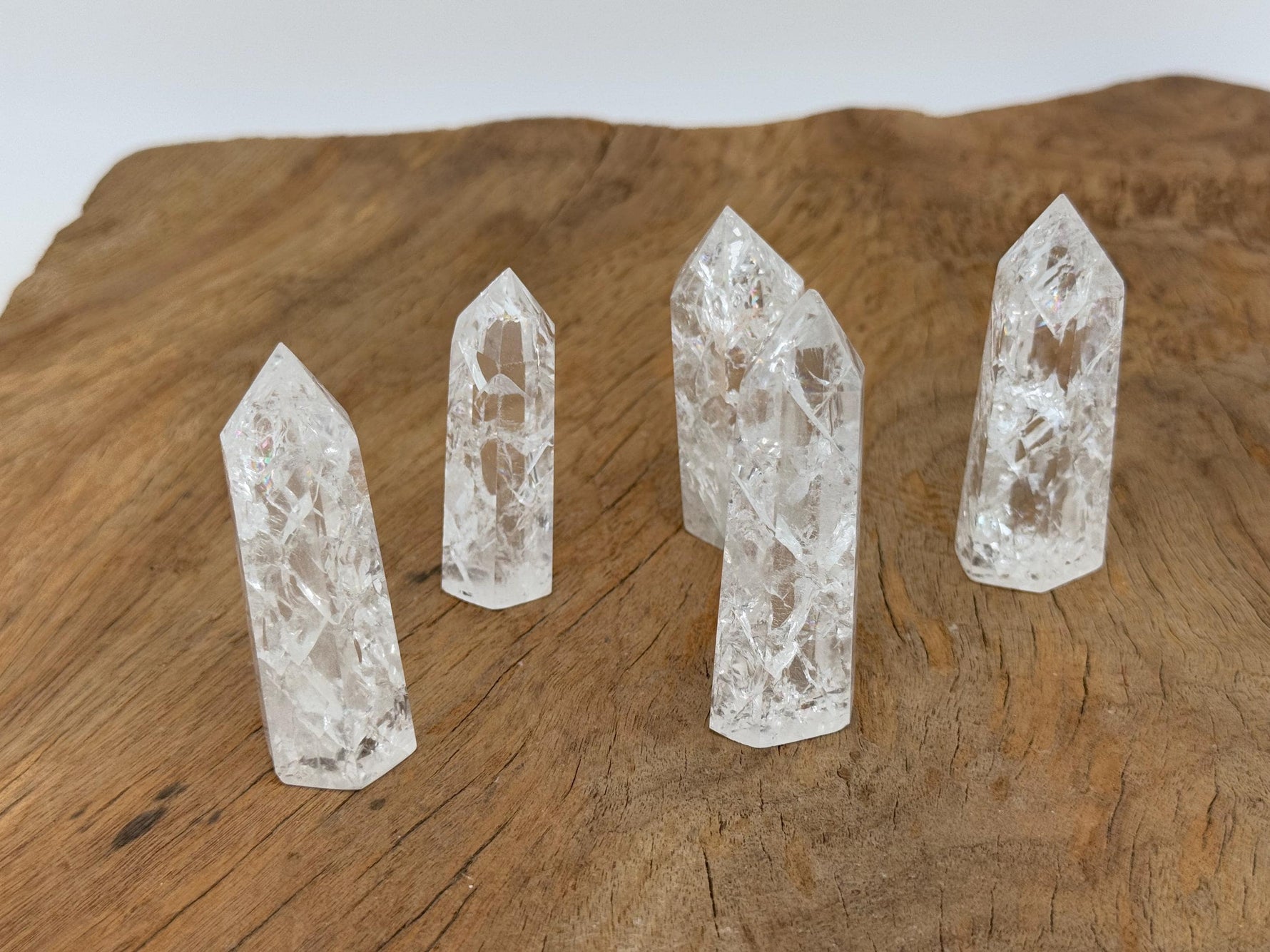 Cracked clear quartz obelisk tower crystal from GemstoneGO, showcasing a tall, pointed clear quartz crystal with natural fractures.