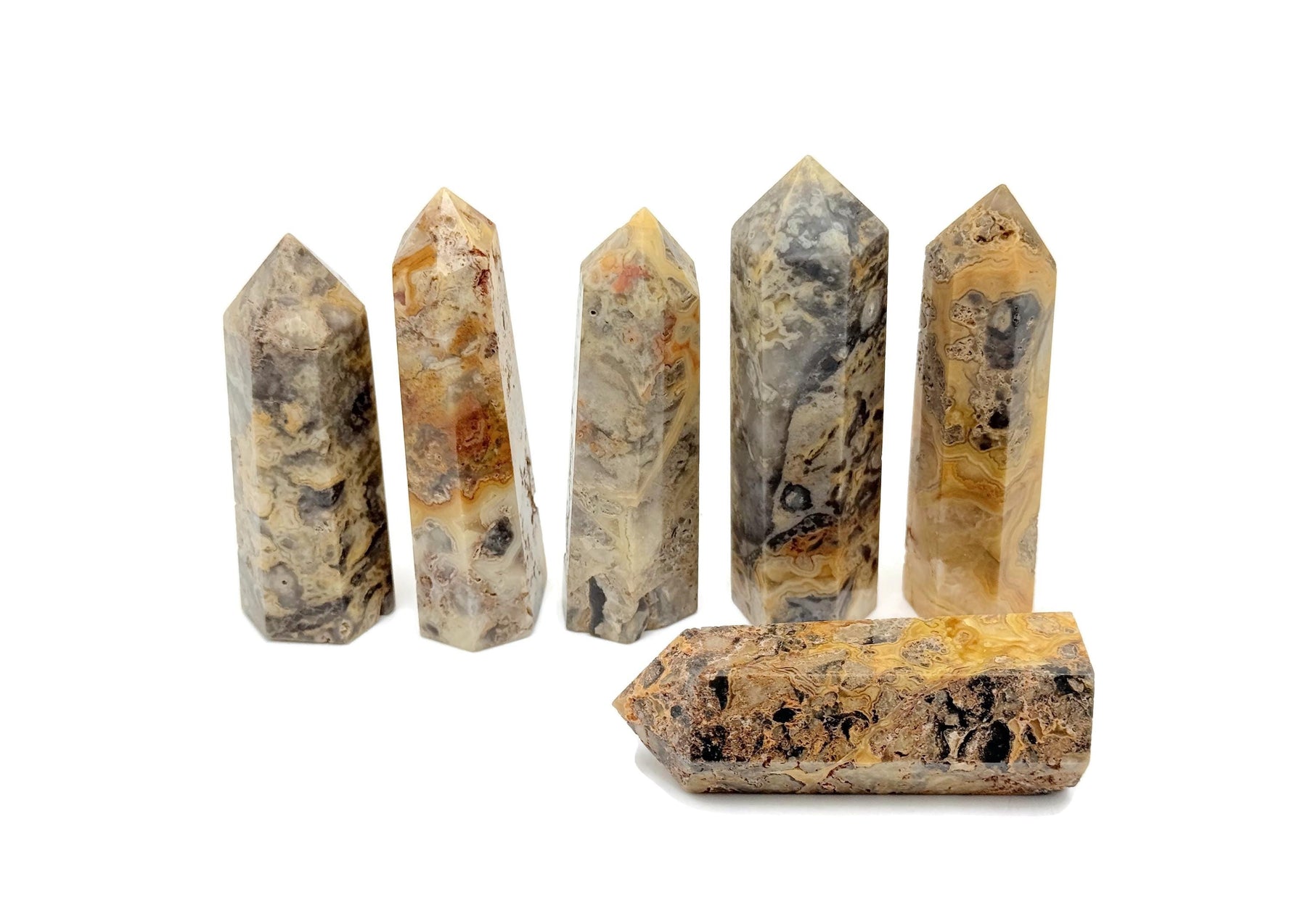 Crazy Lace Agate obelisk tower crystal from GemstoneGO showcasing vibrant, intricate patterns and polished stone surface.