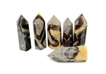 Septarian obelisk tower crystal, also known as dragon stone, from GemstoneGO, showing earthy tones and natural mineral patterns.