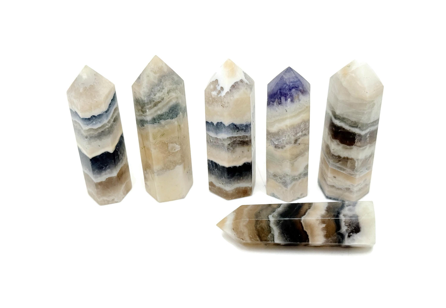Fluorescent fluorite agate obelisk tower crystal from GemstoneGO, showcasing vibrant colors and natural stone patterns.