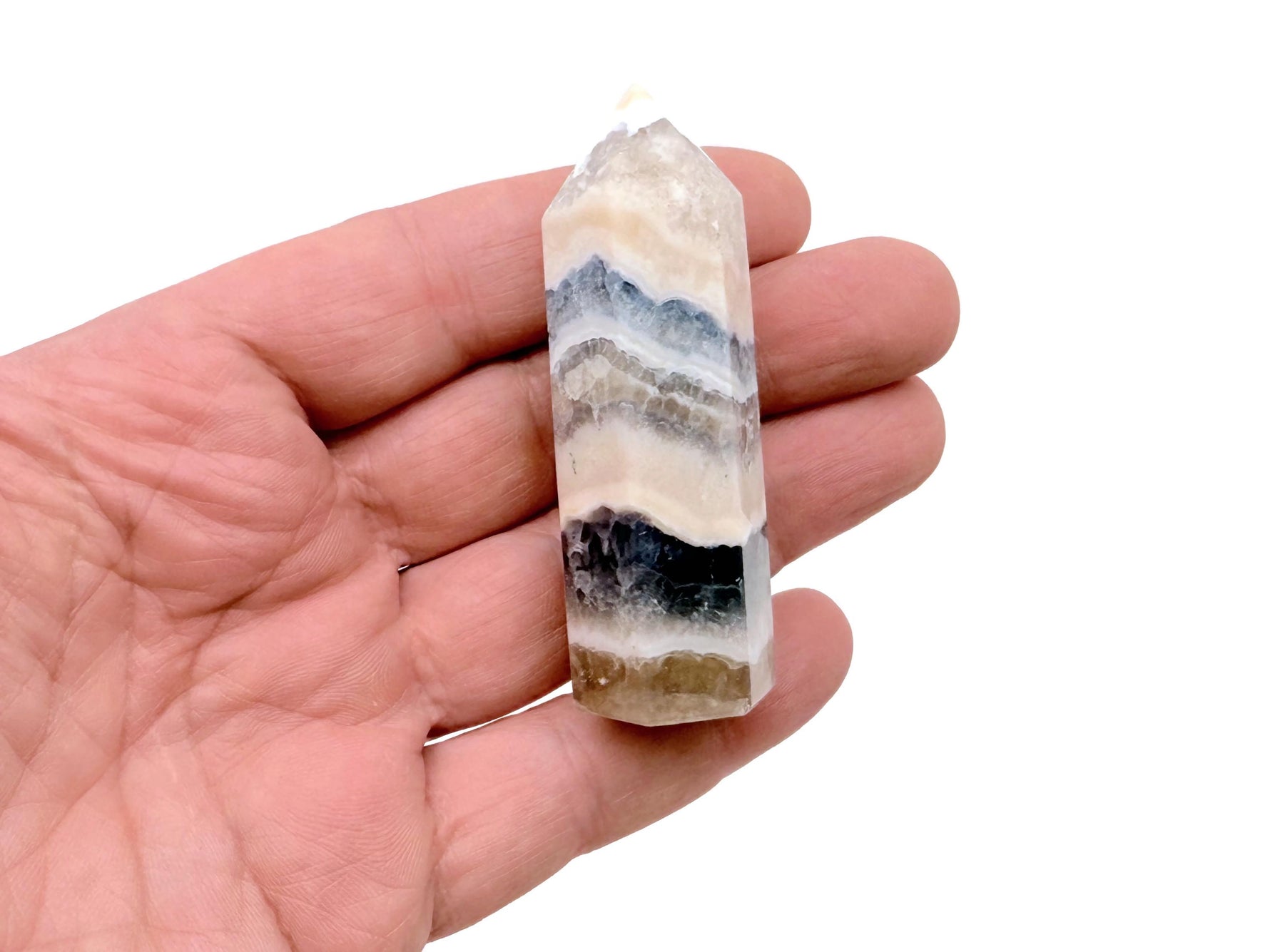 Bright green and purple fluorite agate obelisk tower crystal with natural banding and translucent appearance.